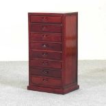 A hardwood narrow chest of small proportions