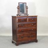 A modern stained pine chest of drawers