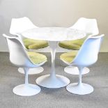 A tulip shaped dining table with a marble top