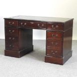 A reproduction mahogany pedestal desk