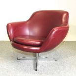 A 1970's Danish red leather upholstered revolving armchair