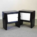 A pair of Art Deco style black and white lacquered bedsides