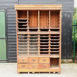 A large early 20th century oak haberdashery cabinet