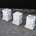 A set of three cast stone garden pedestals