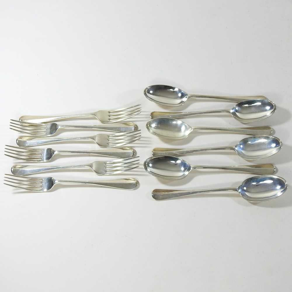 A set of six George V fiddle pattern silver dessert forks and spoons