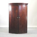 A George III mahogany corner cupboard