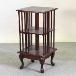 A reproduction mahogany revolving bookcase