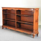 A 20th century continental fruitwood dwarf open bookcase