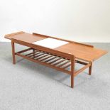 A mid 20th century teak pull out extending coffee table