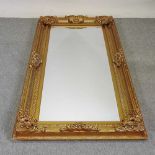 An ornate modern gilt framed wall mirror