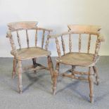 A pair of elm seated captain's chairs