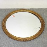 A circular gilt framed wall mirror