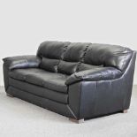 A modern black leather upholstered sofa