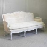 A French carved and painted bergere sofa