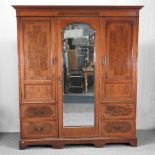 A late Victorian mahogany and inlaid combination wardrobe