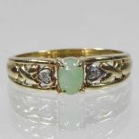 A 9 carat gold diamond and jade ring