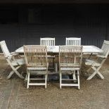 A teak slatted extending garden table