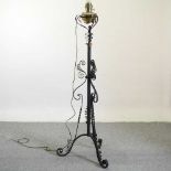 An Arts and Crafts style wrought iron telescopic lamp stand