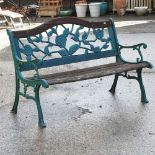 A green painted iron garden bench