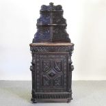 A 19th century carved standing corner cabinet