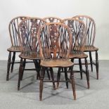 A set of six elm seated wheelback dining chairs