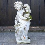 A cast stone garden figure of a cherub
