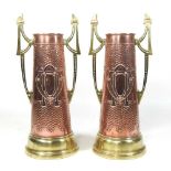 A pair of Arts and Crafts brass and copper vases