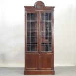 An early 20th century glazed oak bookcase