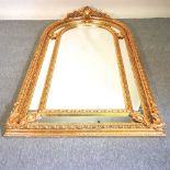 An ornate modern gilt framed wall mirror