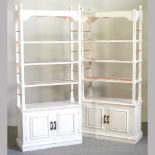 A pair of white painted open bookcases