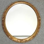 An oval gilt framed wall mirror