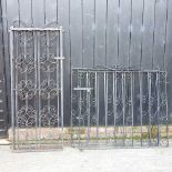 A pair of black painted wrought iron garden gates