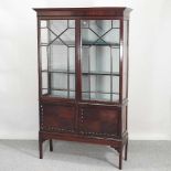 An Edwardian mahogany astragal glazed display cabinet