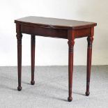 A mahogany folding card table