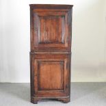 A George III oak standing corner cabinet