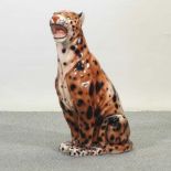 A large painted plaster model of a seated cheetah