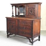 An early 20th century carved oak sideboard