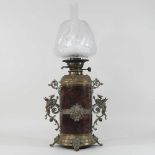 A 19th century brass mounted hardstone oil lamp