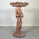 An Italian 18th century style style carved wooden figural bird bath