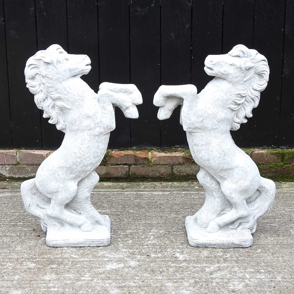 A pair of reconstituted stone horses