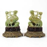 A pair of Chinese carved jade coloured stone birds