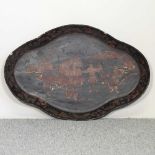 An early 20th century black lacquered tray