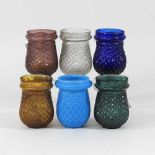 A collection of coloured glass tea lights