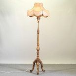 A carved and gilt painted standard lamp