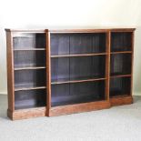 A Victorian light oak dwarf breakfront open bookcase