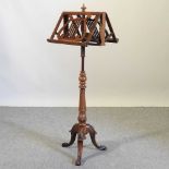An early 20th century walnut duet stand
