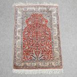A Persian silk prayer rug