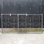 A pair of black painted wrought iron garden gates