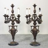 A pair of bronze figural two branch candelabra