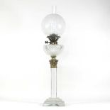 A 19th century clear glass oil lamp
